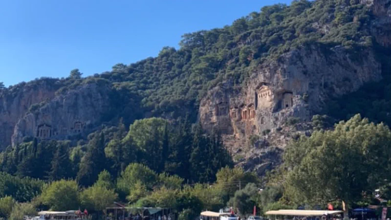 The Kaunos rock tombs lit by the setting sun above the river The Kaunos rock tombs lit by the setting sun above the river
