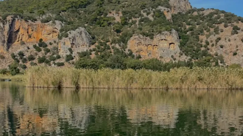 Armchairs on a wooden jetty facing the rock tombs across the water Armchairs on a wooden jetty facing the rock tombs across the water